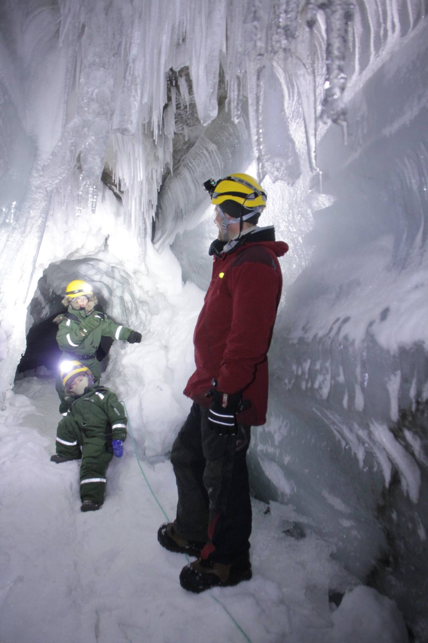 A guide and two children inside the ice cave