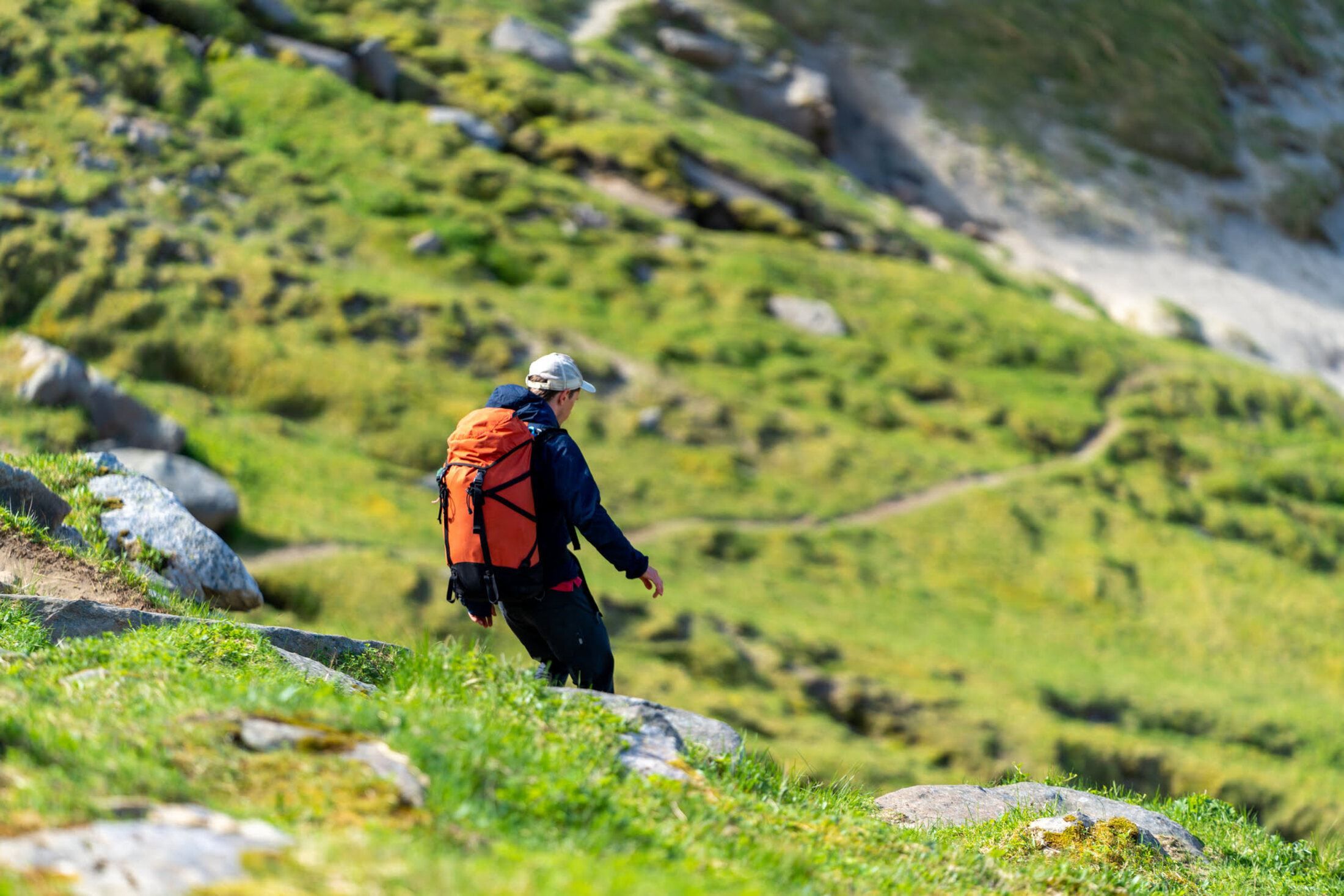 one person hiking down the hill