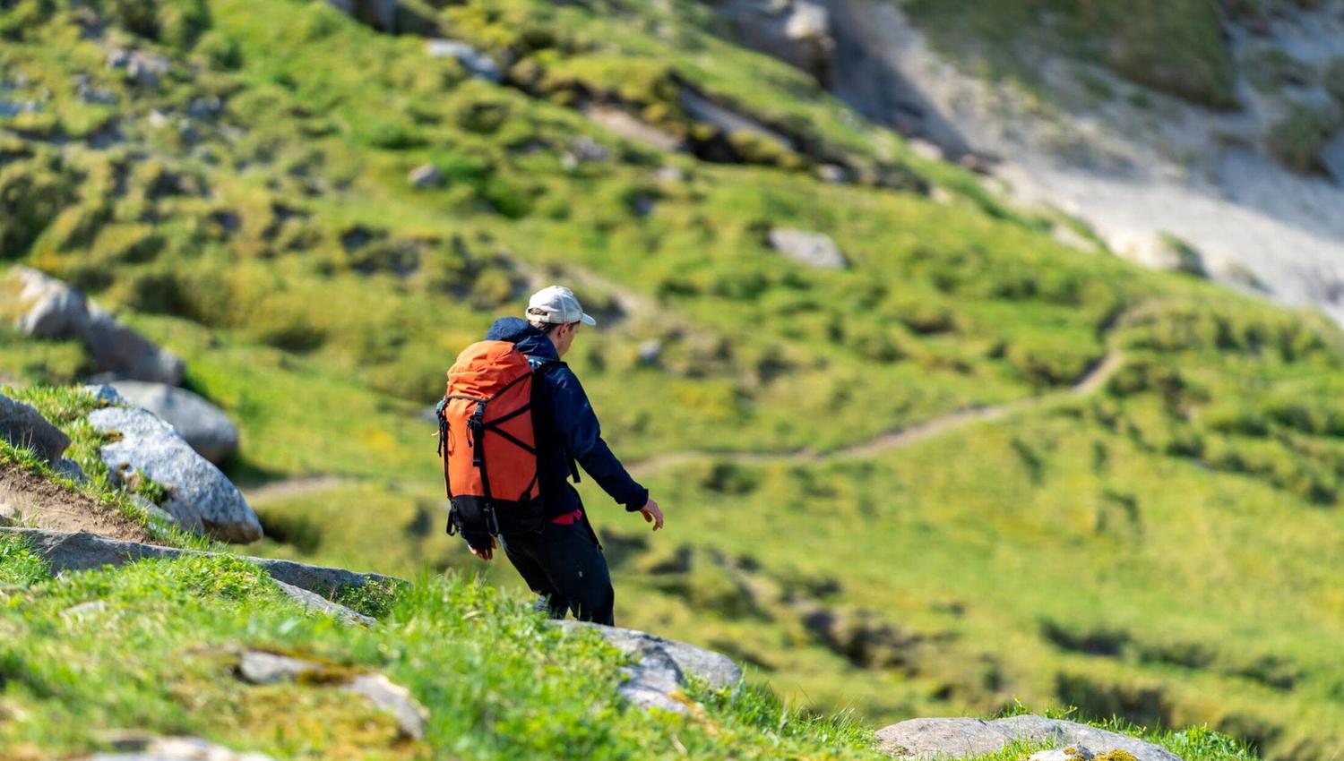 one person hiking down the hill