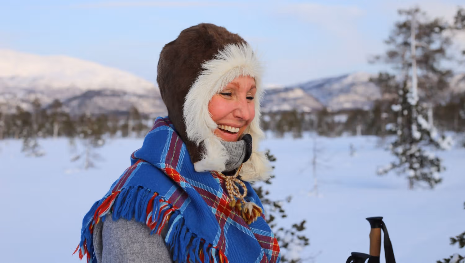 smiling woman outside in winter landscape