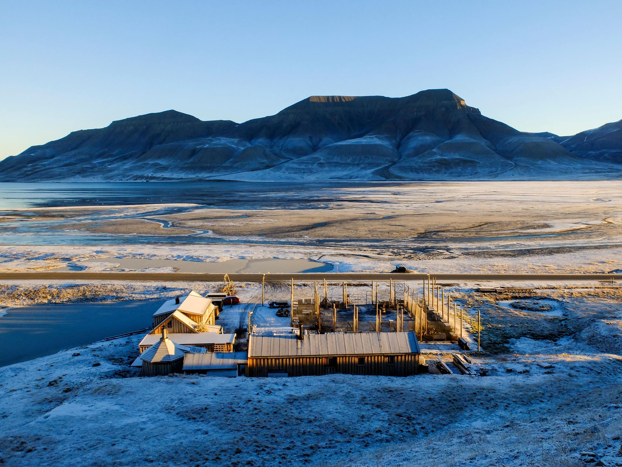 Tommy's Lodge with an open valley and a mountain in the background