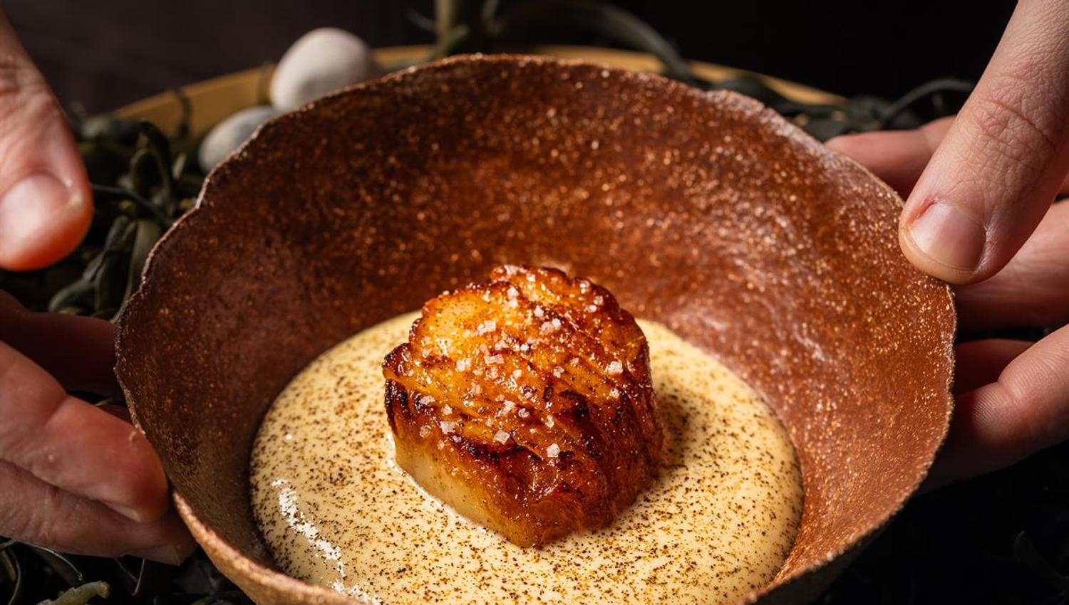 Refined dish with a creamy base and garnish.