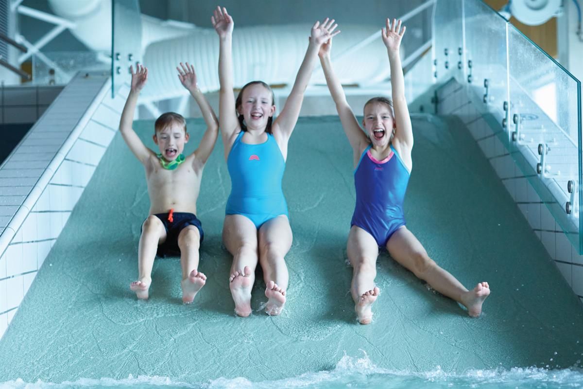 Tree happy children in a water slide
