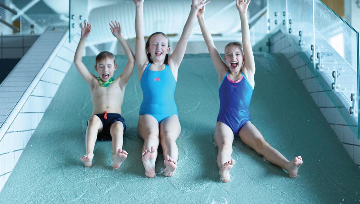 Tree happy children in a water slide