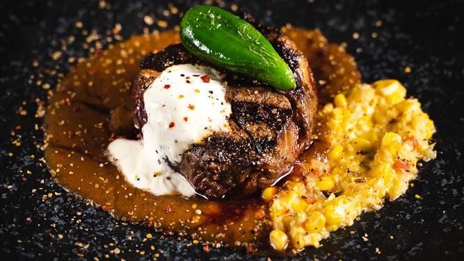 steak with sauce, chili and corn