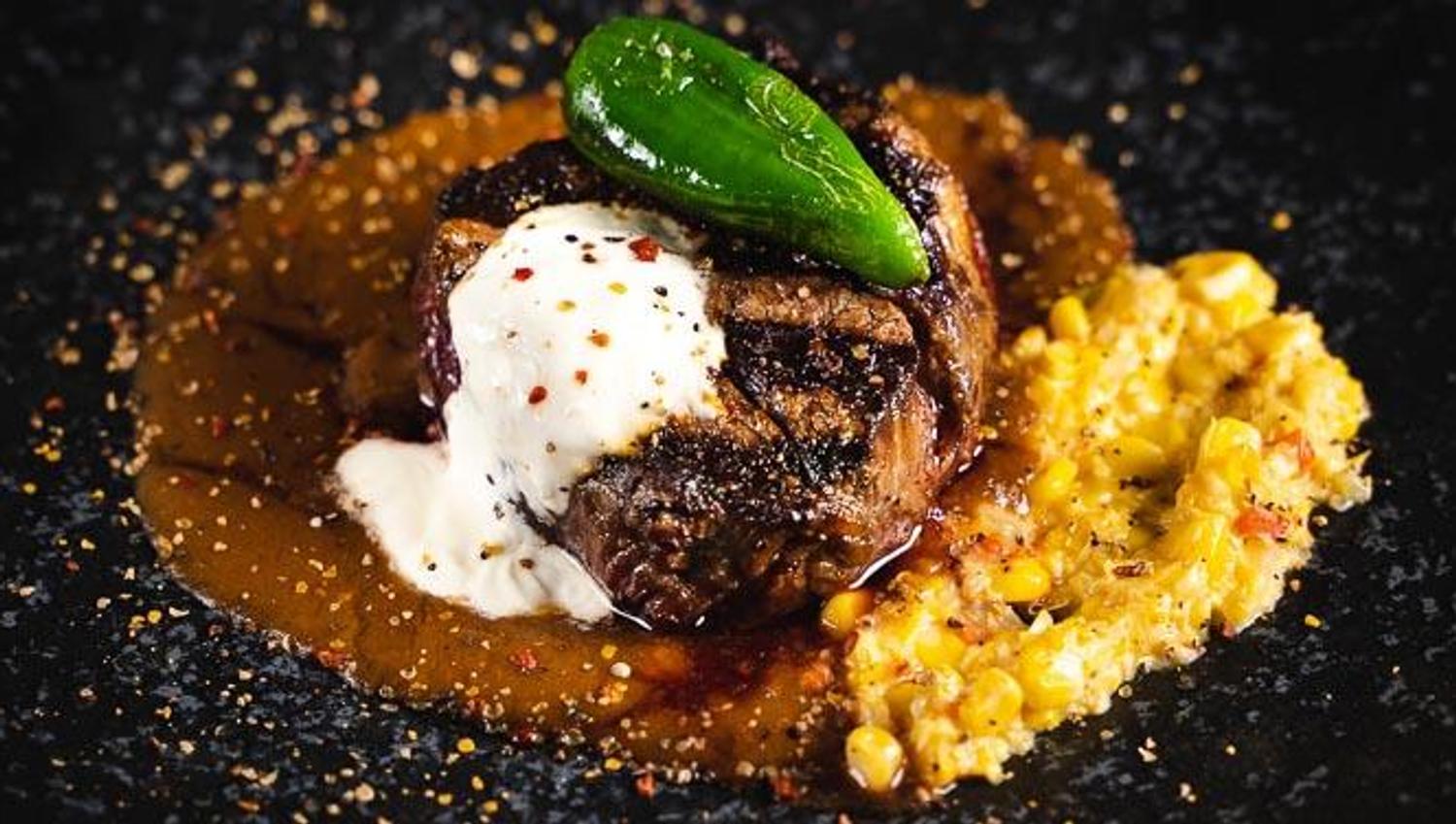 steak with sauce, chili and corn