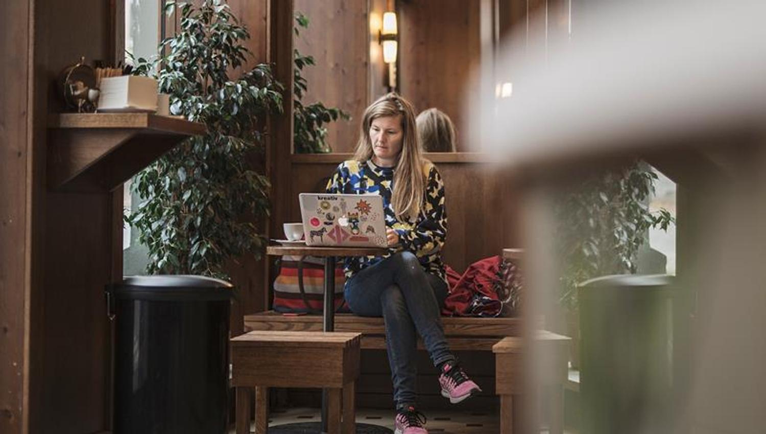 woman working on her laptop from the café