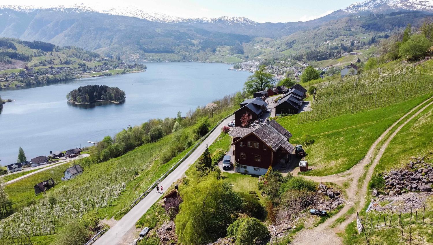 Aerial view of Syse Gard, surrounded by orchards and fjord landscapes in Hardanger.