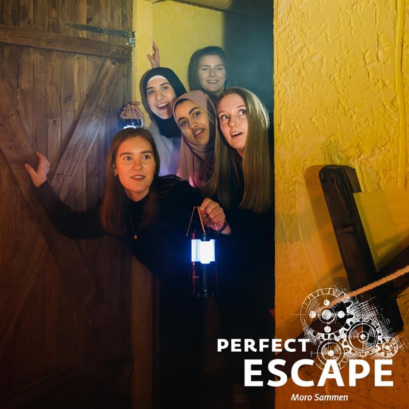 a group of women peering excitedly through a doorway with lanterns in hand