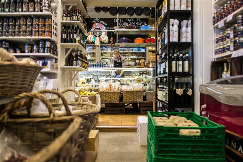 Shop interior: Lots of exciting wares to purchase, employee standing behind the counter.
