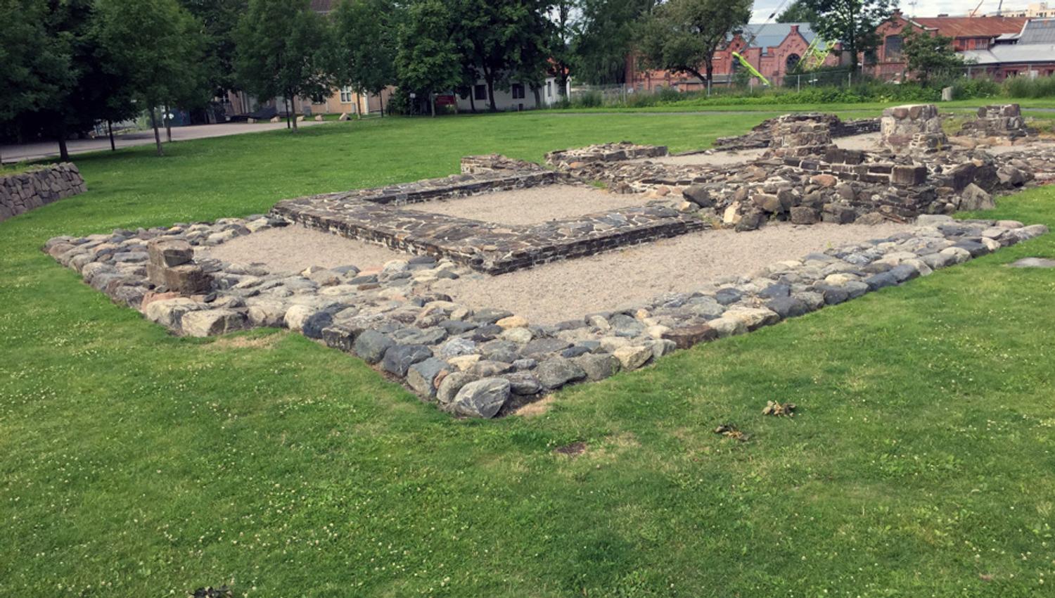Stone ruins on a lawn.