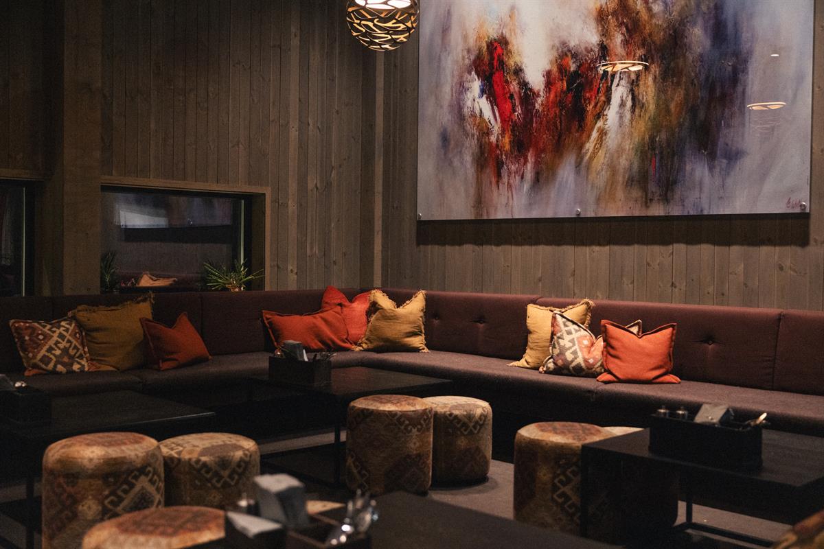Cozy restaurant lounge with fireplace and seating.
