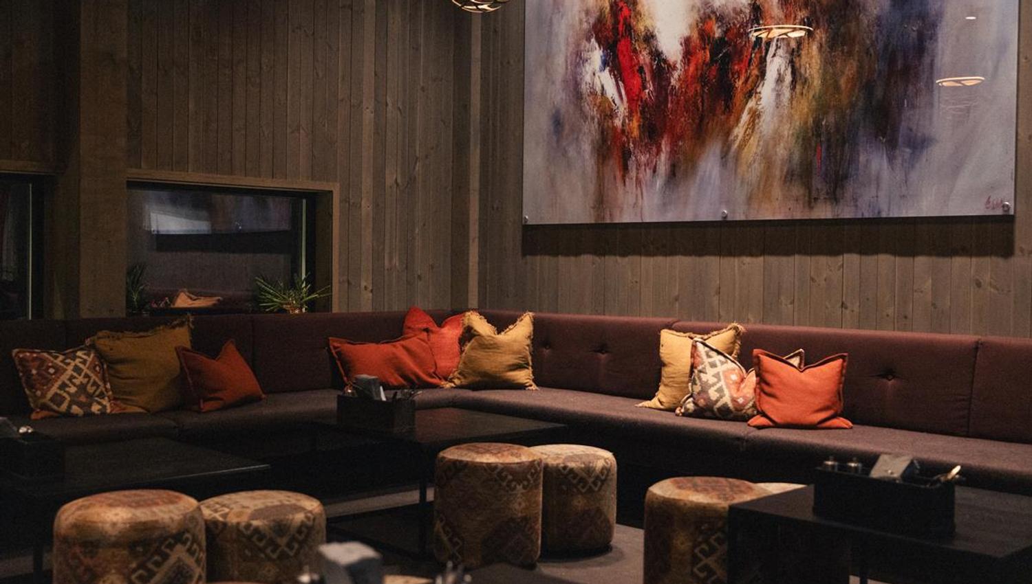 Cozy restaurant lounge with fireplace and seating.