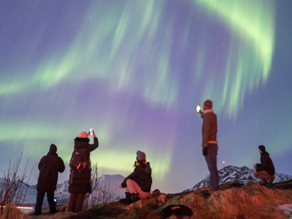 Guests taking pictures of the northern lights