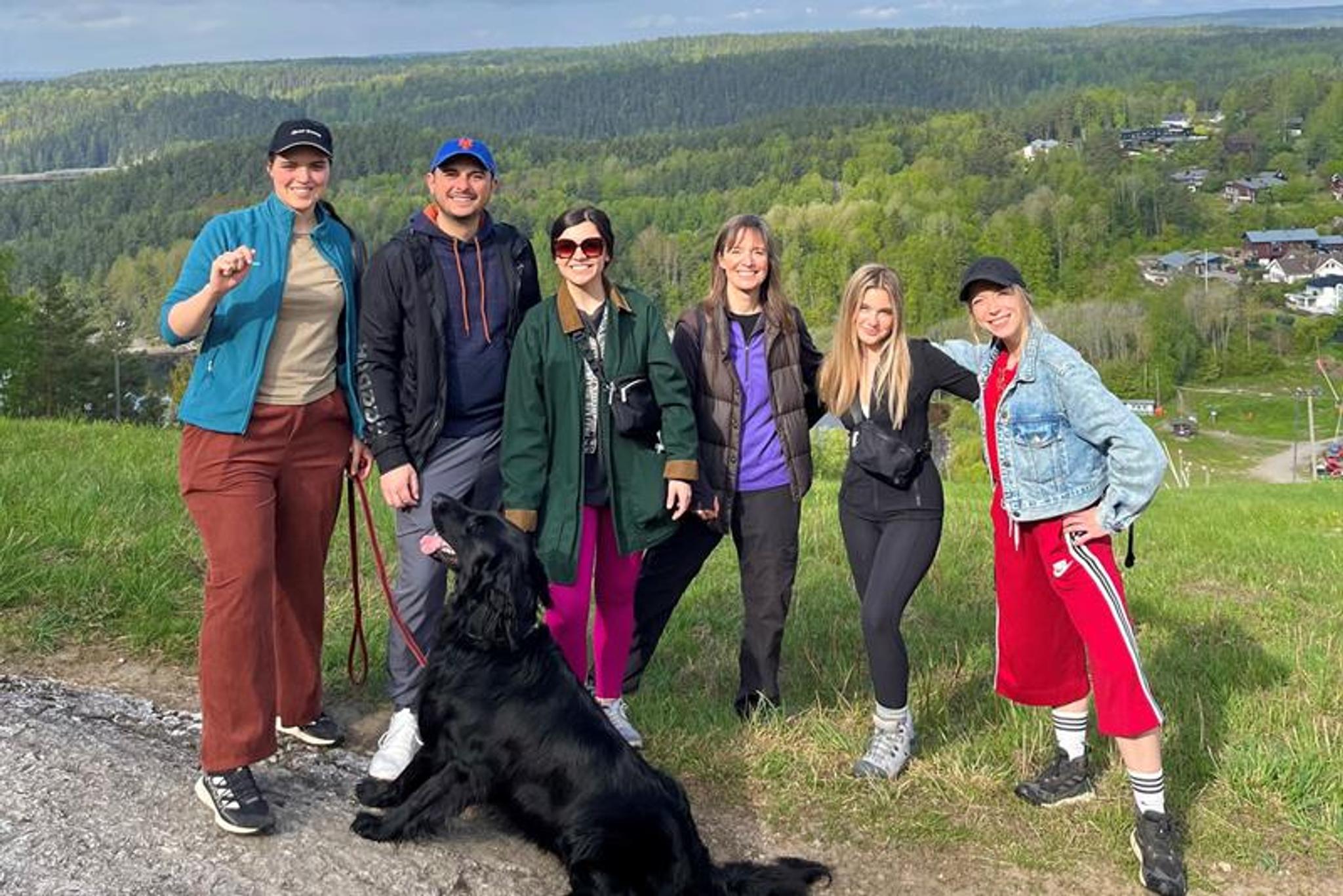 A group of people and a dog on a hike