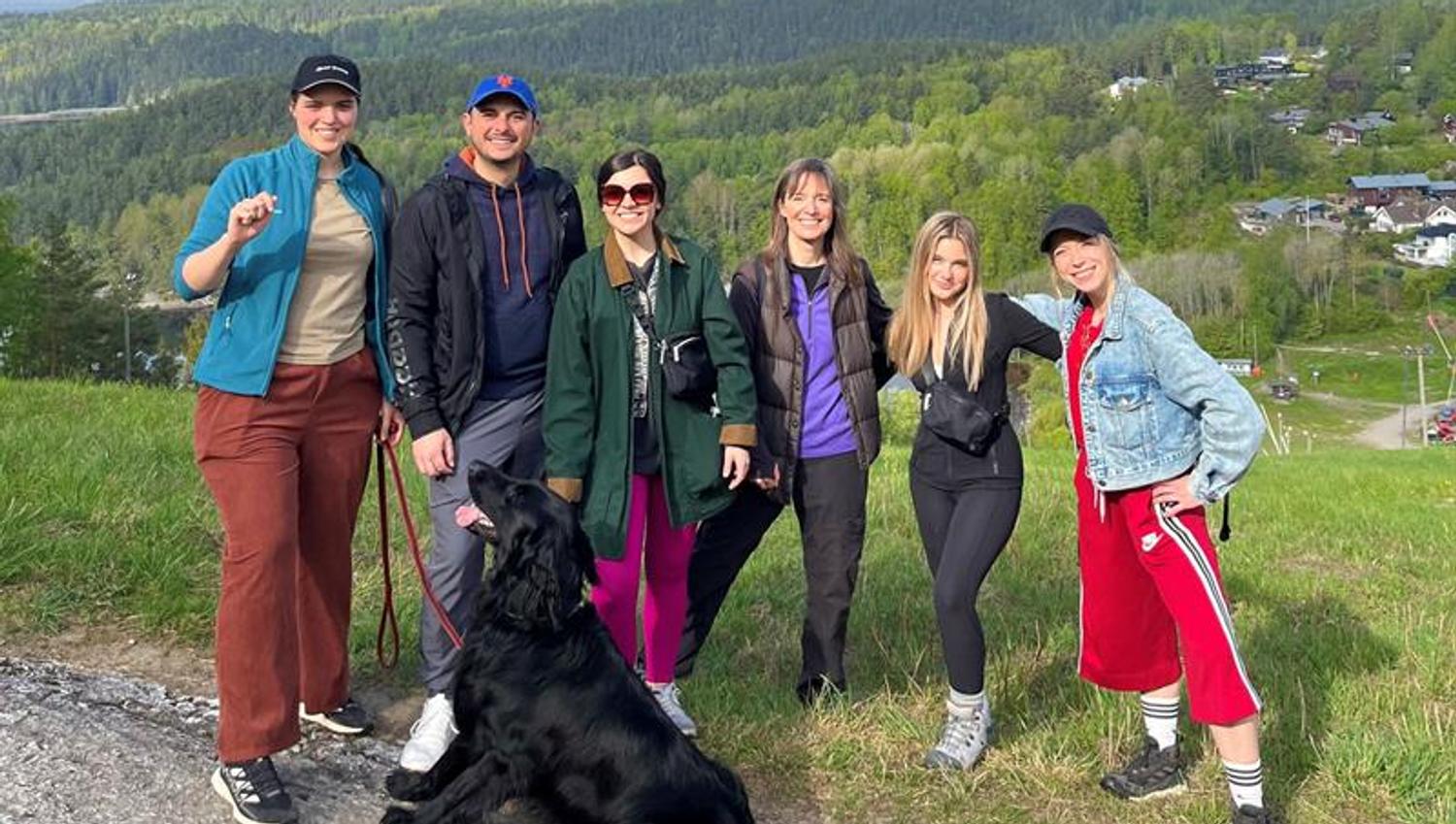 A group of people and a dog on a hike