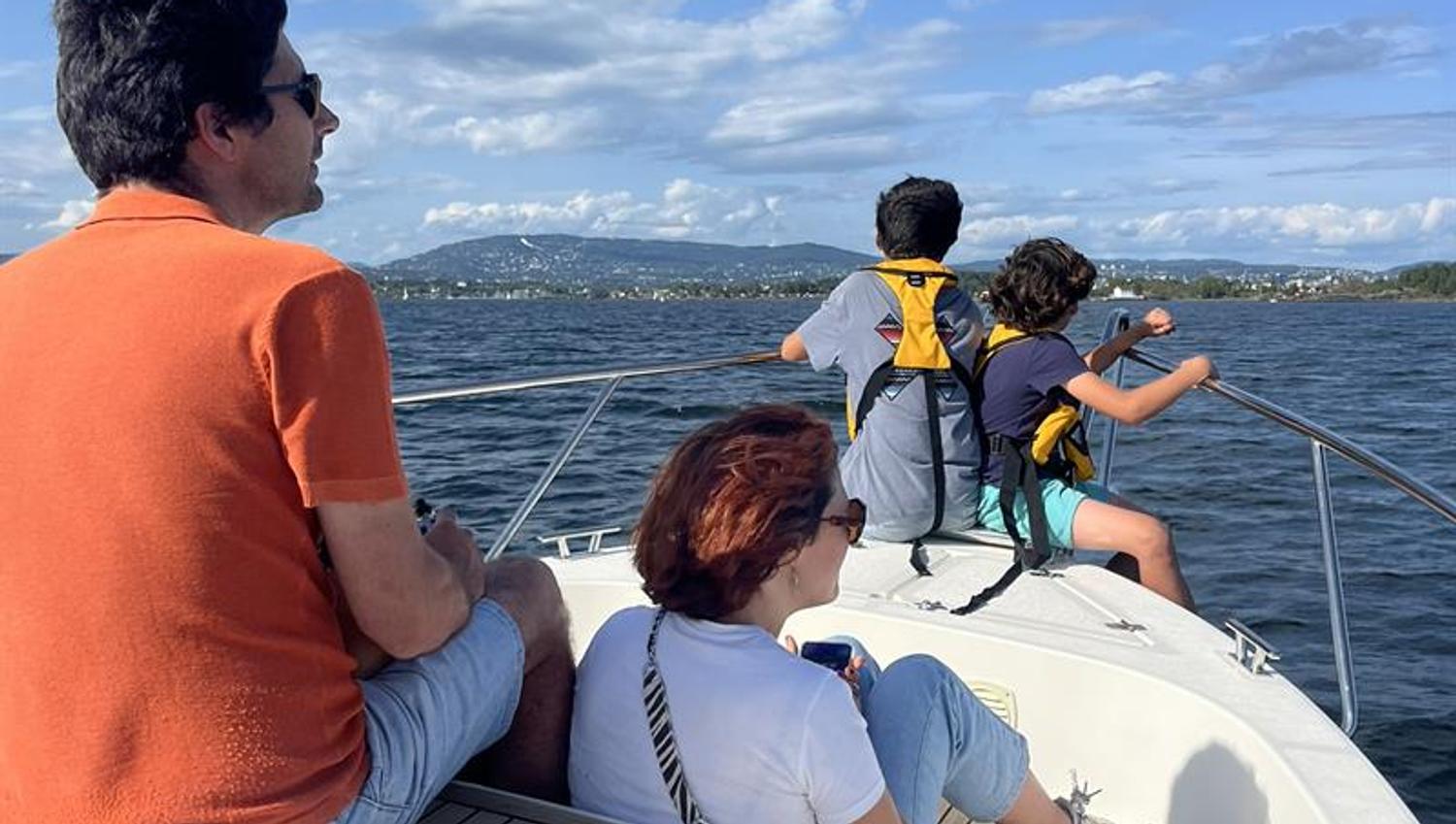 Family on front deck of boat, sea view