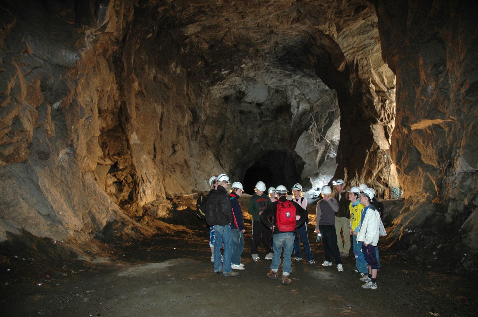A group of visitors on a guided tour inside the tunnels of Lilletopp, where industrial history meets adventure.