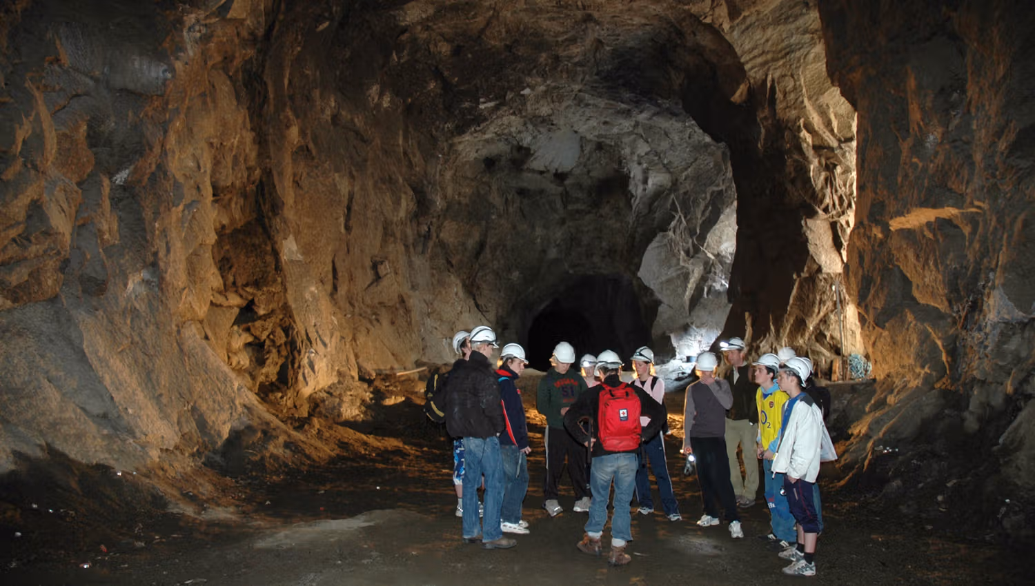 A group of visitors on a guided tour inside the tunnels of Lilletopp, where industrial history meets adventure.