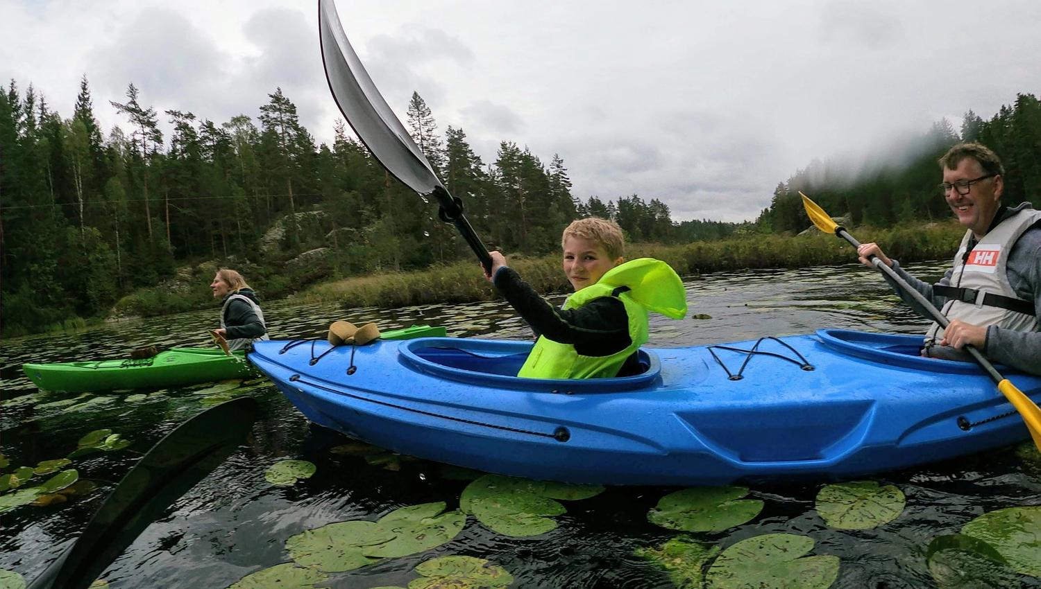 a family with a childe people padling on a lake