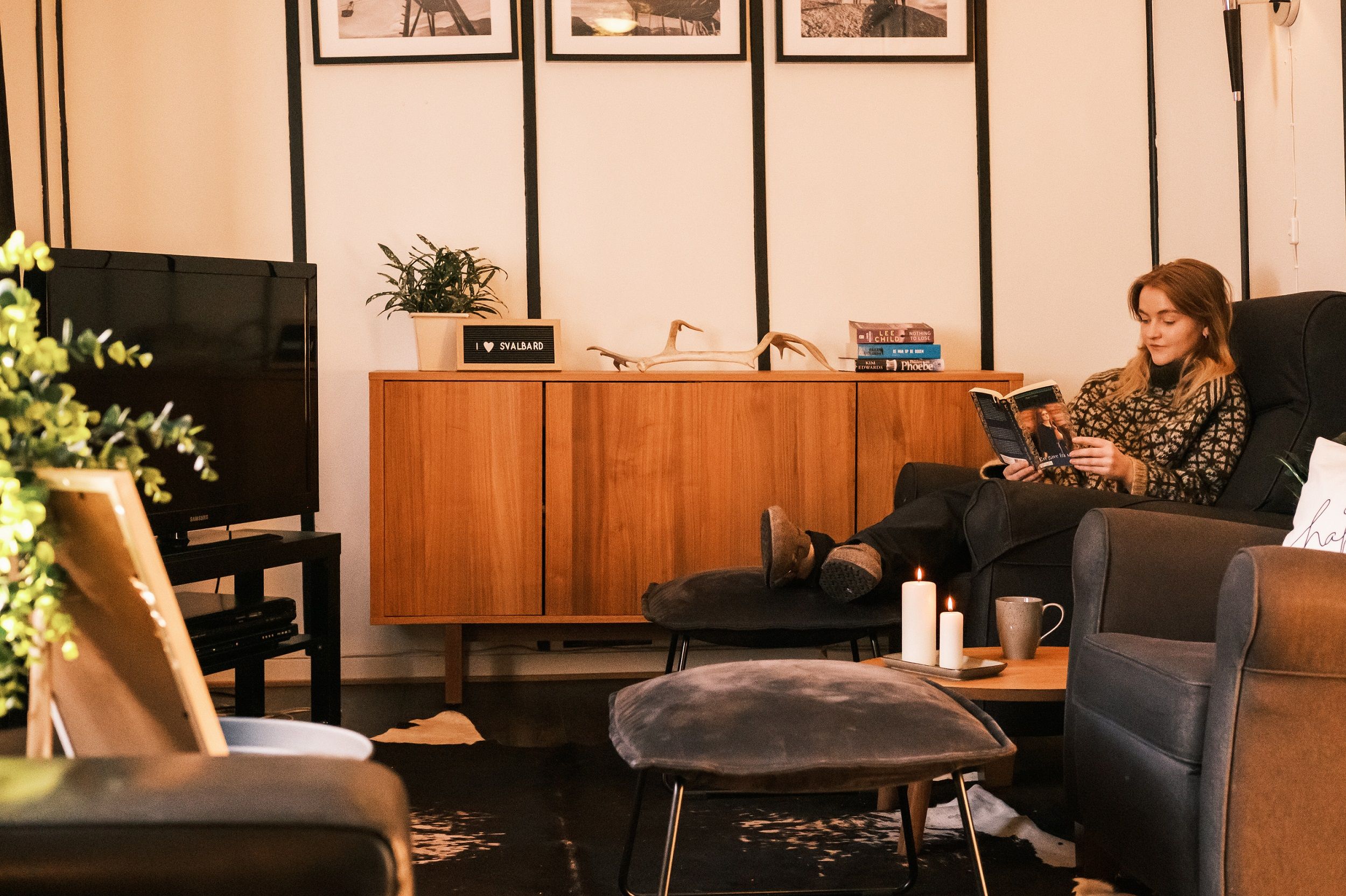 A person reading a book in a common room