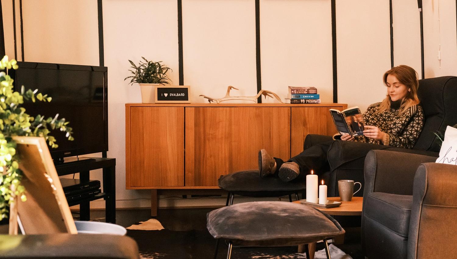 A person reading a book in a common room