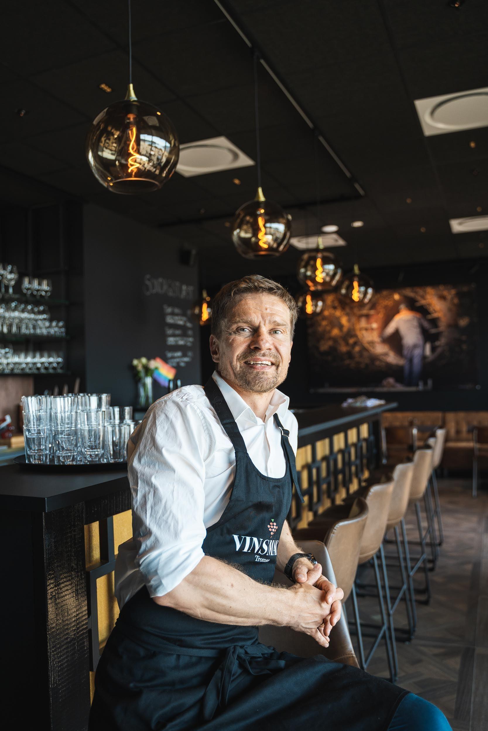 Waiter by the bar smiling