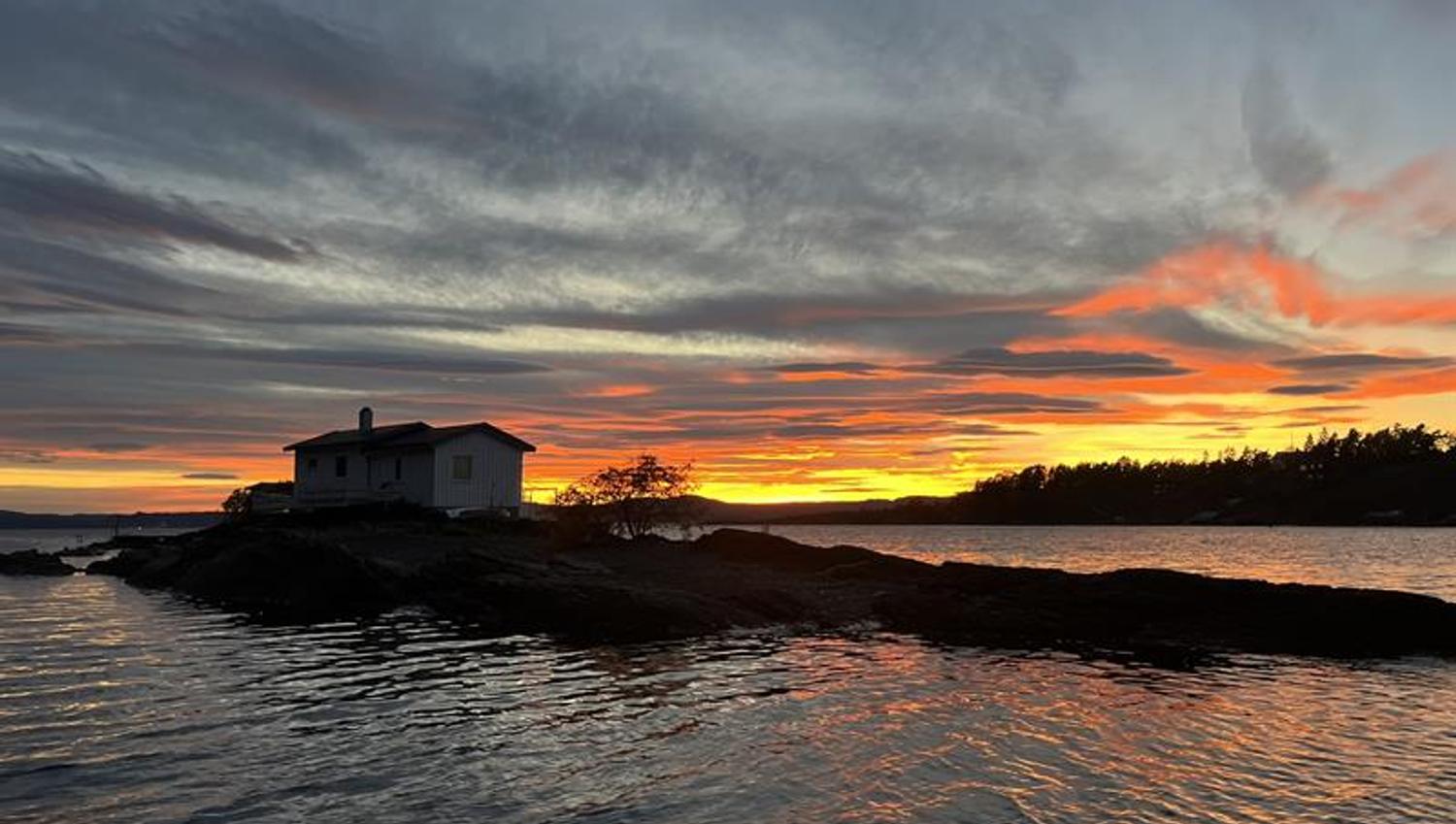 Sunset at the fjord with red and yellow sky
