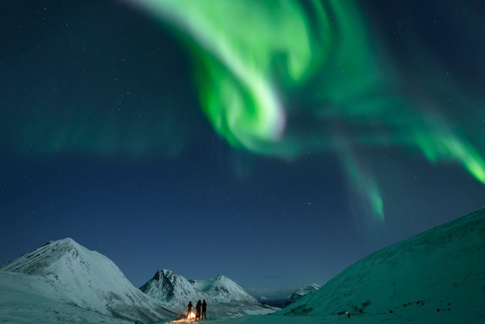 Aurora shines above the mountains
