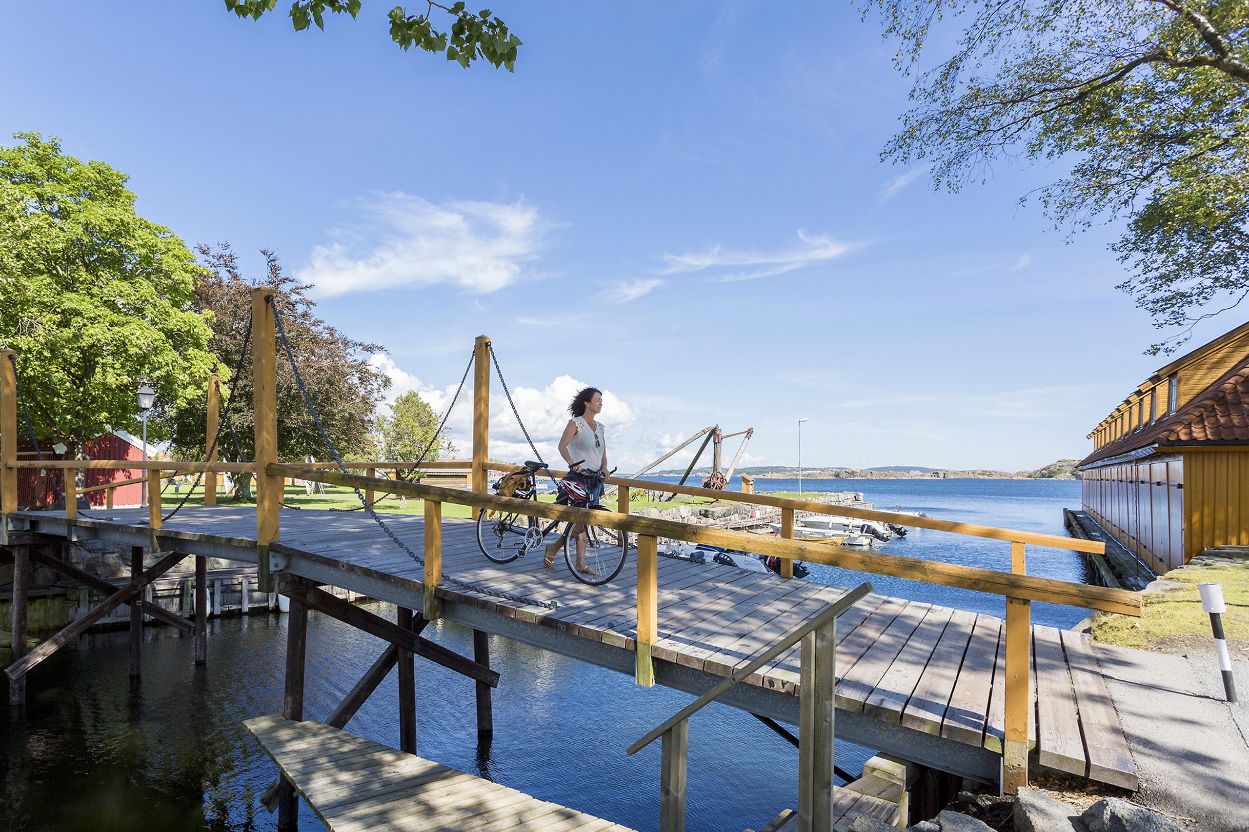 One who goes by bicycle over a small bridge
