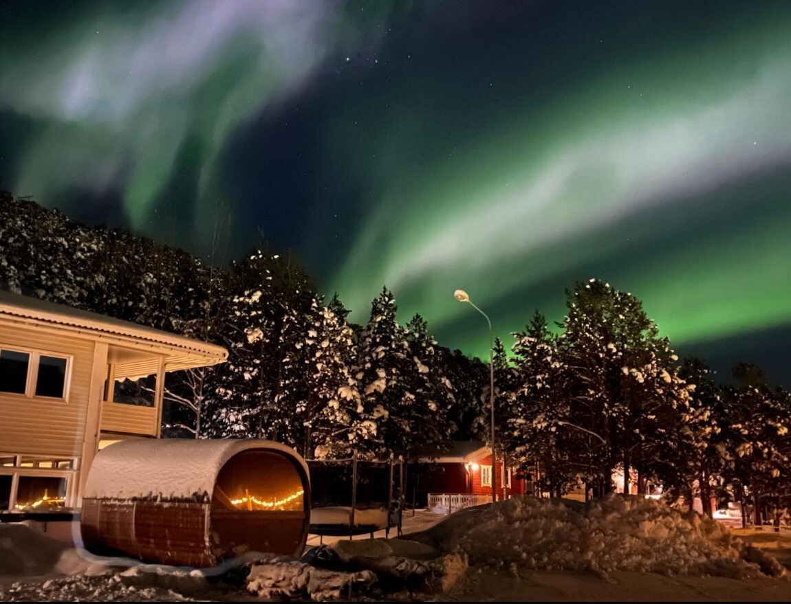 Strong northern lights directly above the hotel