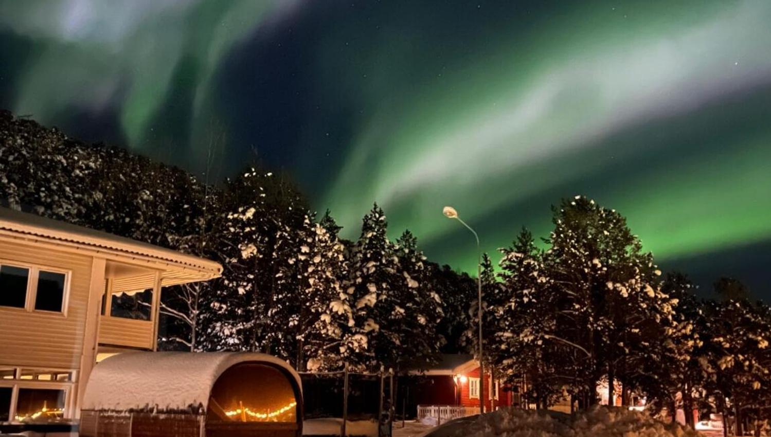 Strong northern lights directly above the hotel