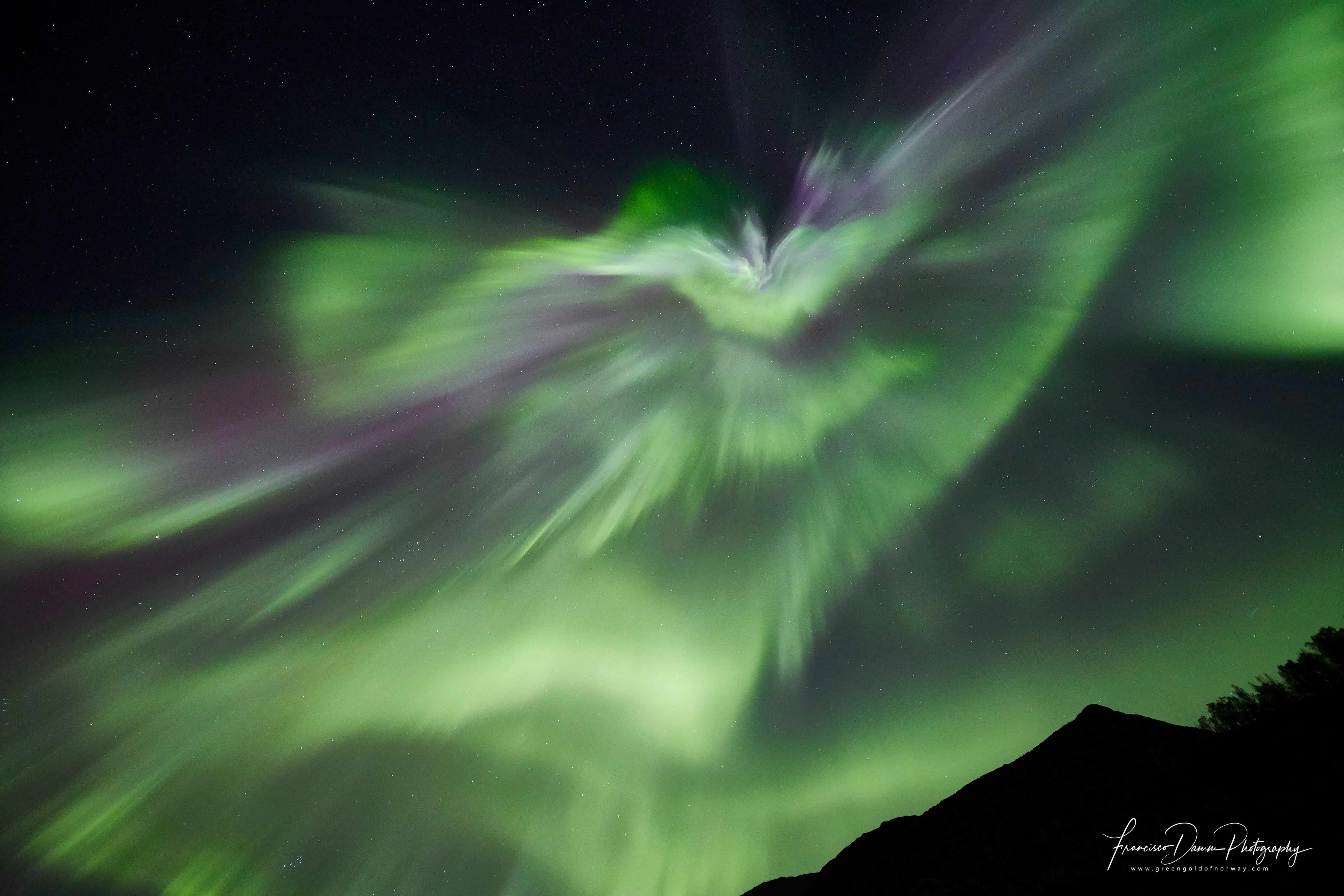 strong northern lights dancing in the sky