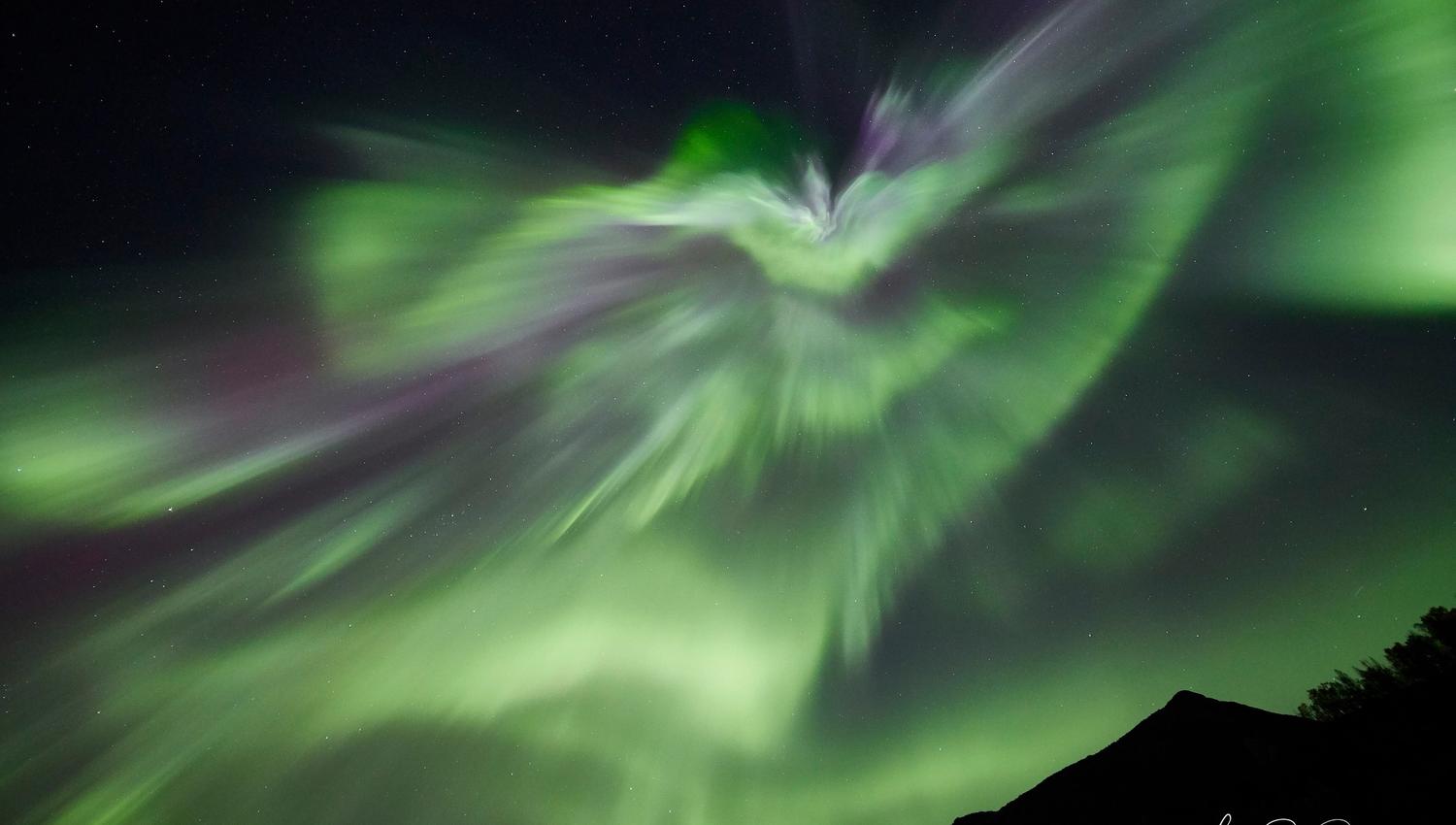 strong northern lights dancing in the sky