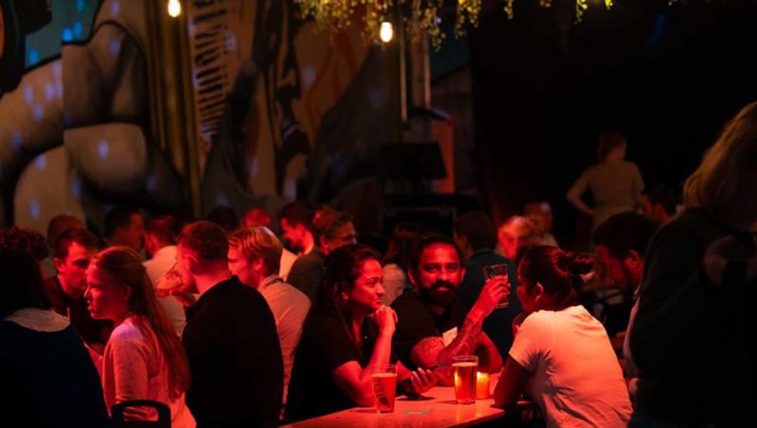 People drinking beer by the tables