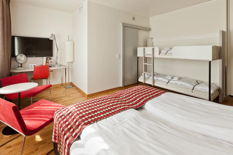 family room with double bed and bunk bed, seating and TV at desk