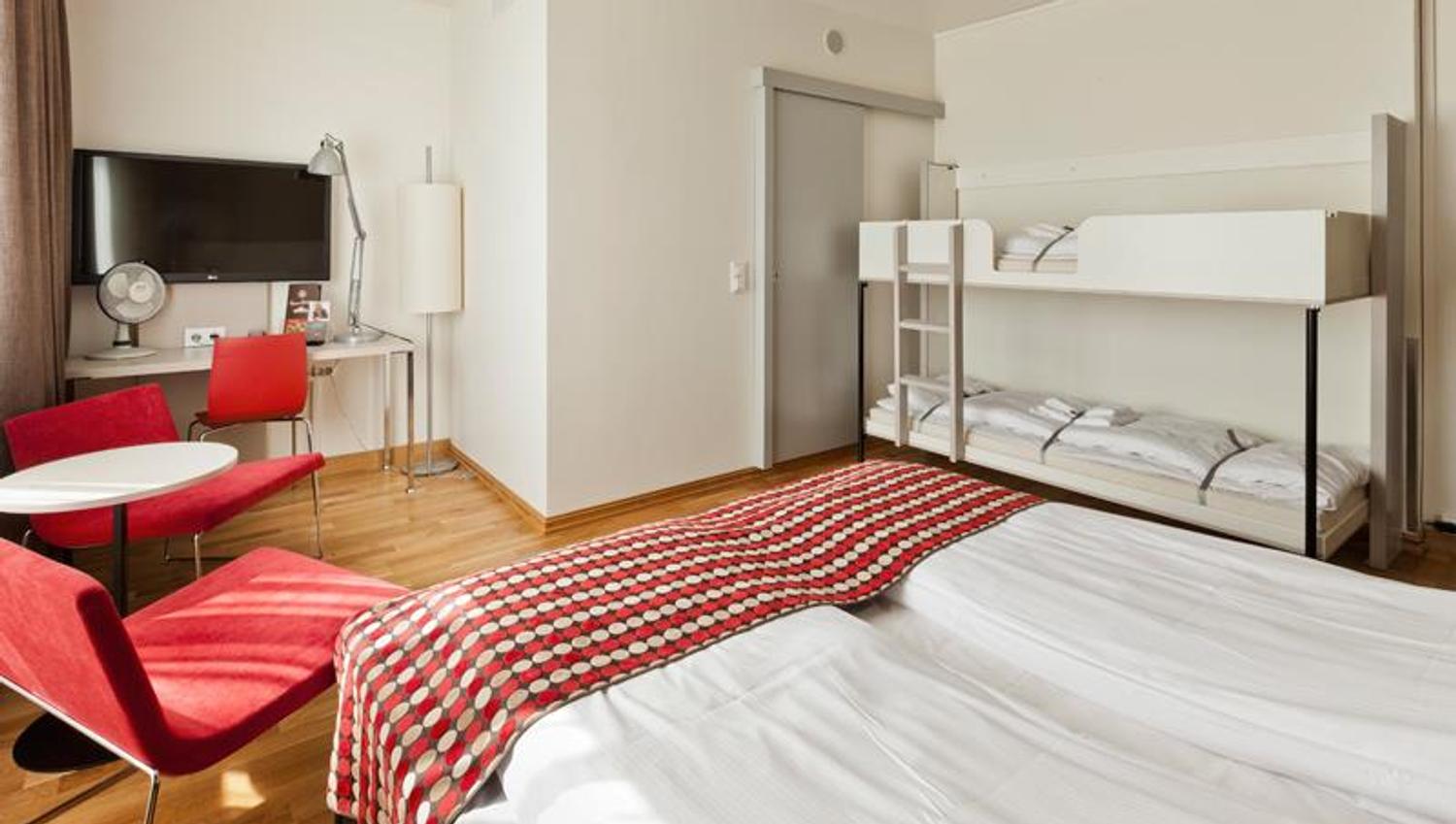 family room with double bed and bunk bed, seating and TV at desk