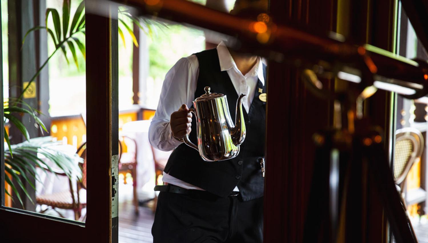 Lady holding a coffee pot