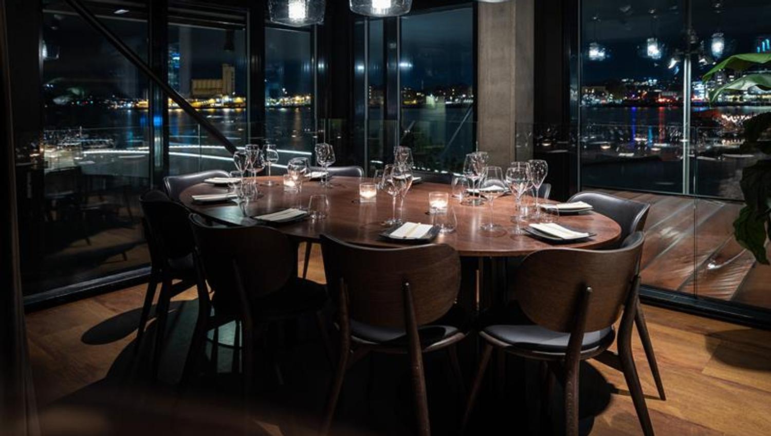 A table set for dining with a view of MUNCH in the background