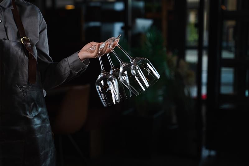 waitress with wine glasses in her hand