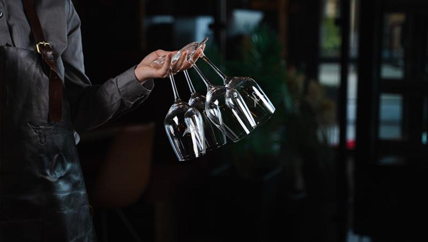 waitress with wine glasses in her hand