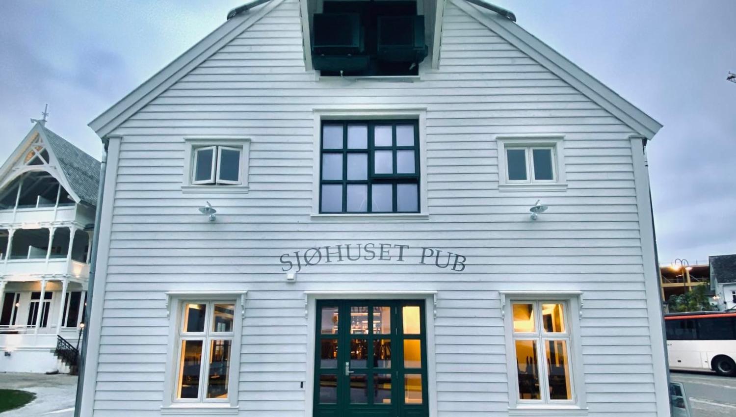 Sjøhuset Restaurant & Pub in Norheimsund - a cozy waterfront establishment with large windows overlooking the Hardangerfjord. Modern Nordic interior d