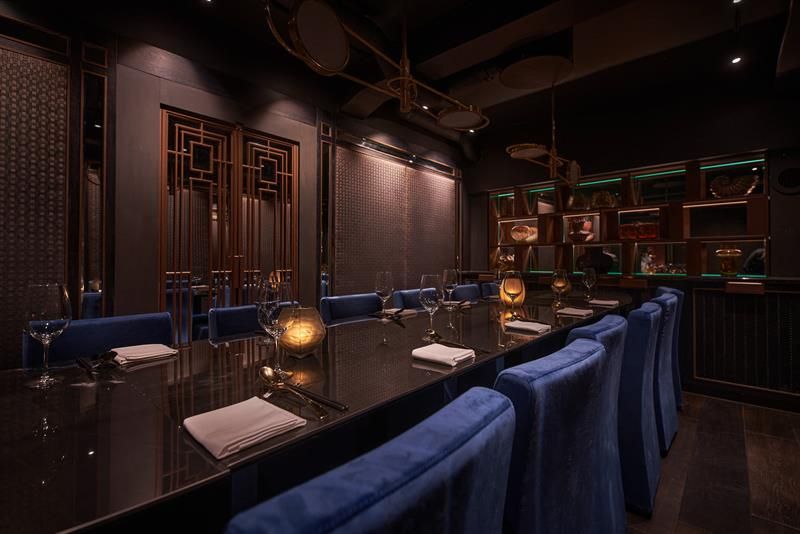 Long table set for dining and blue chairs