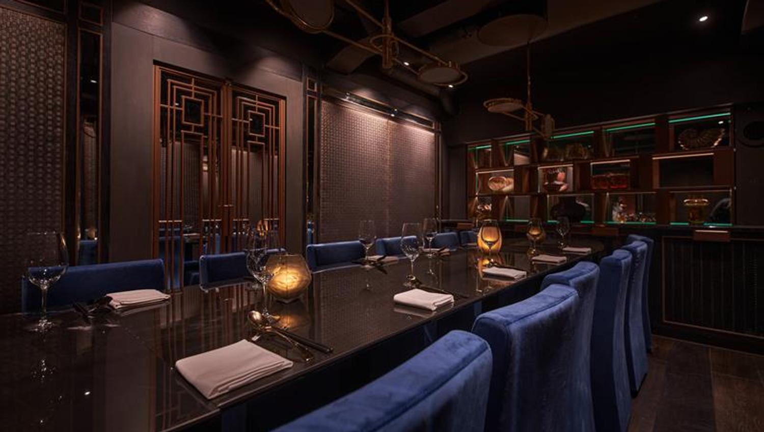 Long table set for dining and blue chairs