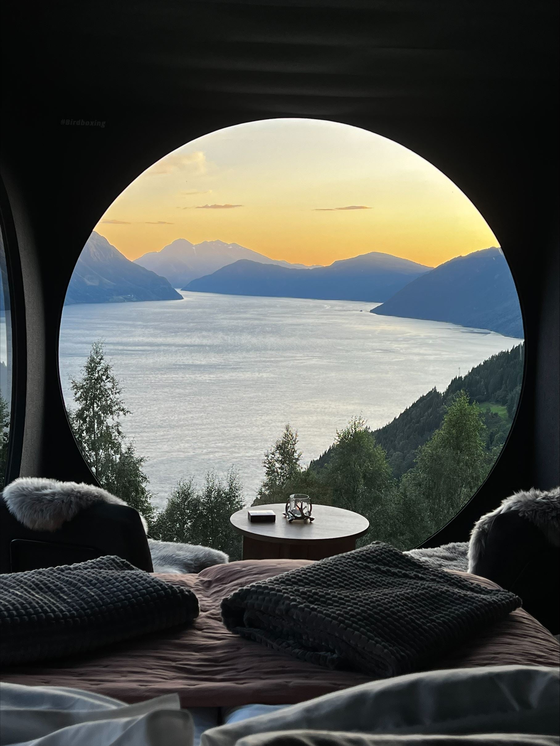 Stunning panoramic view from the Birdbox cabin at Skaara Living on Lotsberg in Nordfjord, surrounded by mountains and fjord landscape.