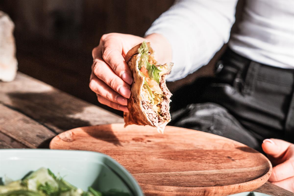 Sandwich held over a cutting board.