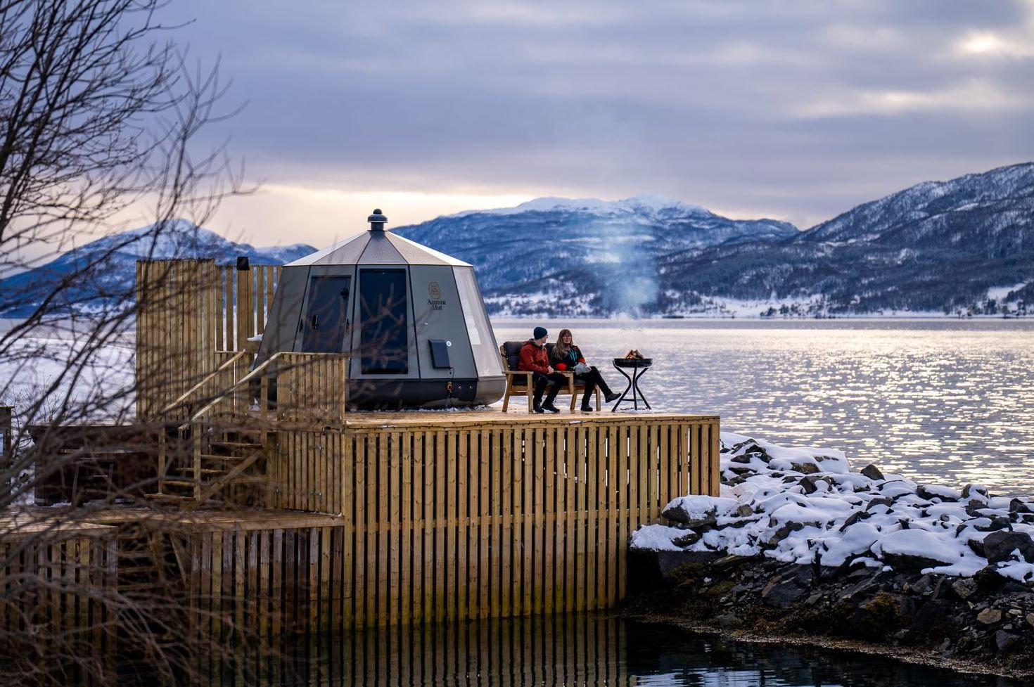 Guests sitting on dock by a little hut