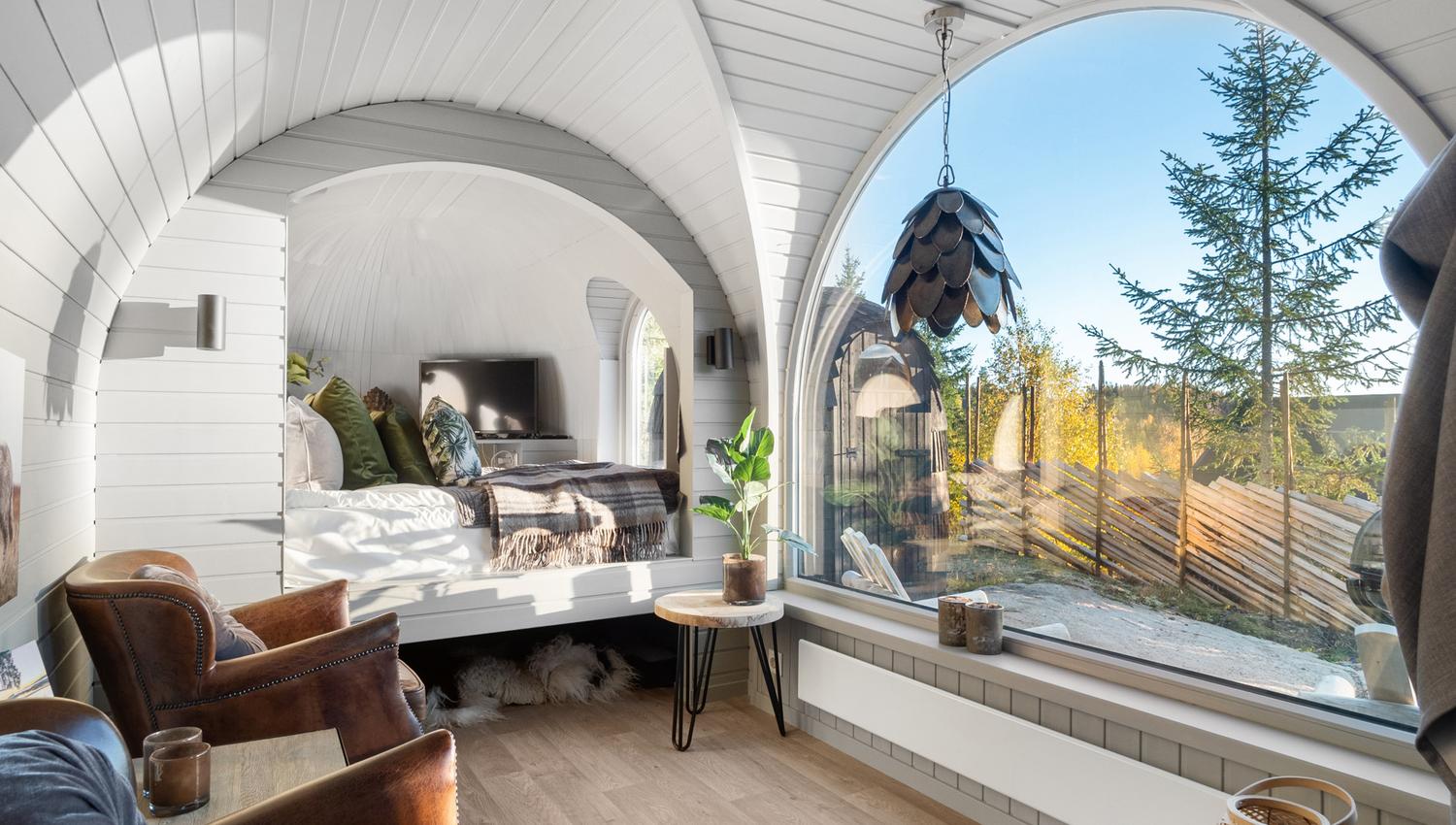 bed, chairs and a big panorama window with view
