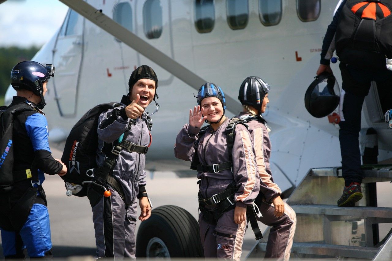 Smiling people entering the plane