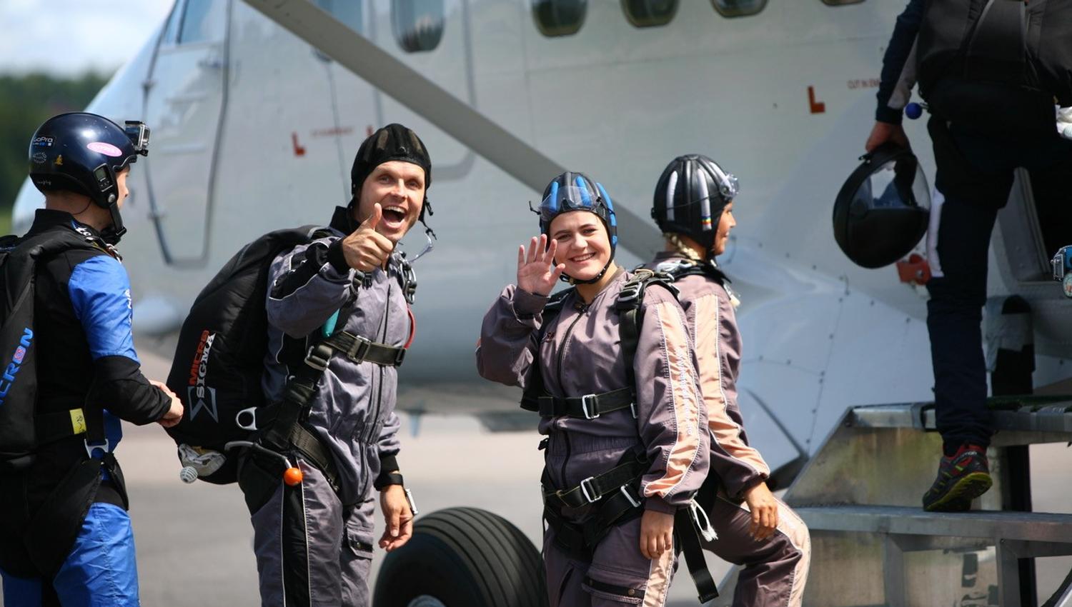 Smiling people entering the plane